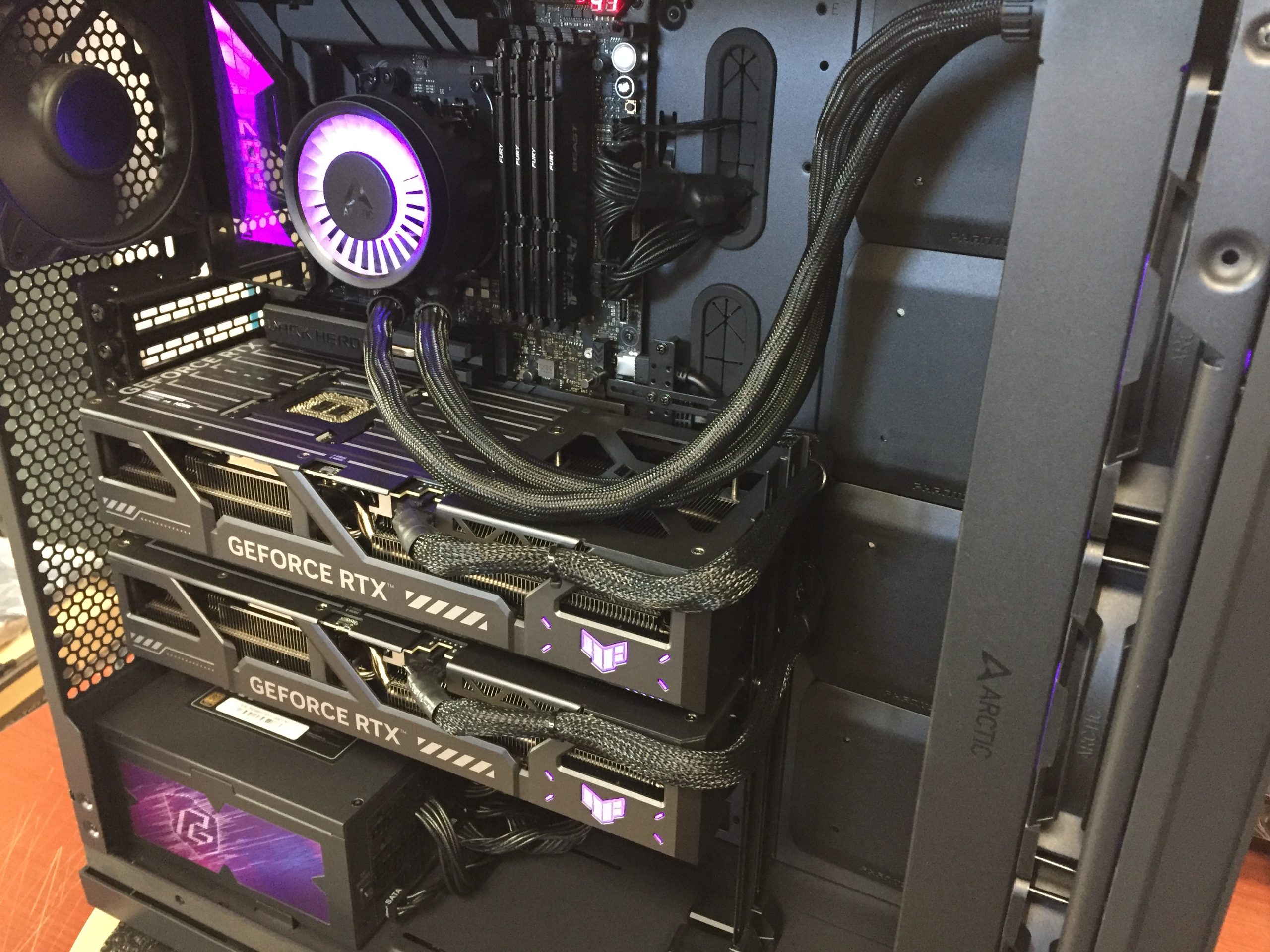 Dual RTX 5090 GPUs installed in MES2X chassis showing cooling hardware and cable management under full AI training load