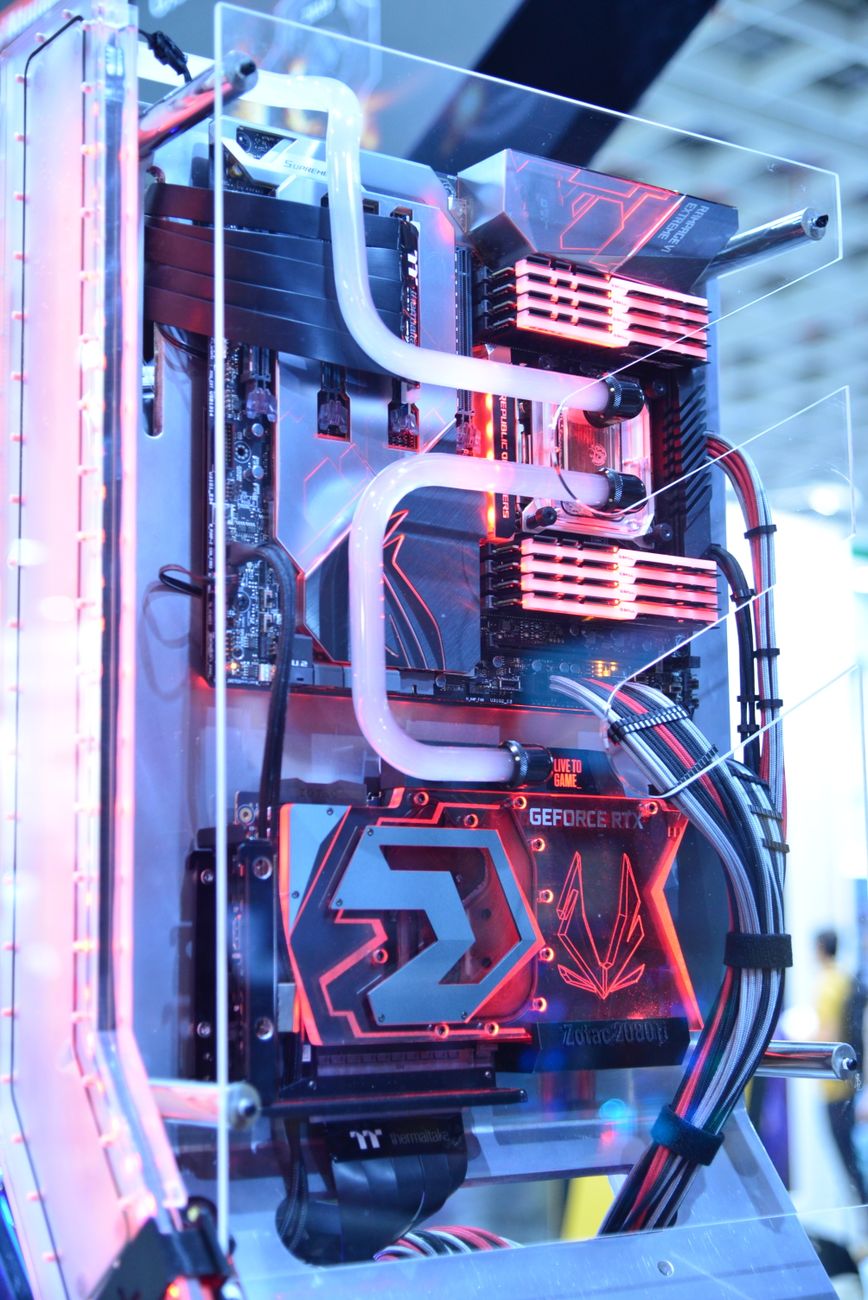 Custom water loop with white coolant in hard tubing running across RAM and a GPU water block
