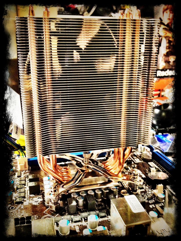 A single-tower air cooler mounted on a Ryzen CPU inside a mesh-front case